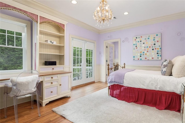 bedroom featuring light hardwood / wood-style flooring, ornamental molding, access to exterior, a notable chandelier, and french doors