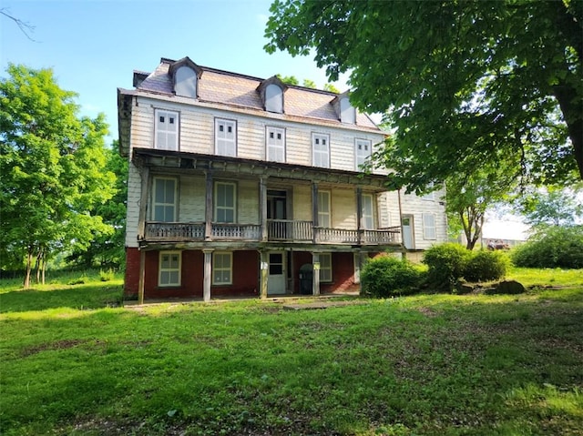 back of property with a lawn