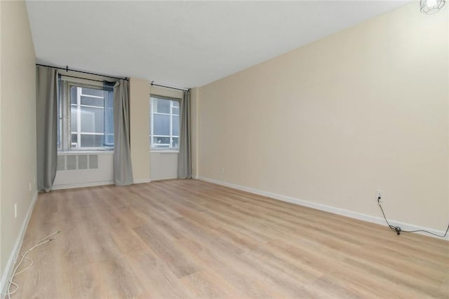 spare room featuring light hardwood / wood-style flooring