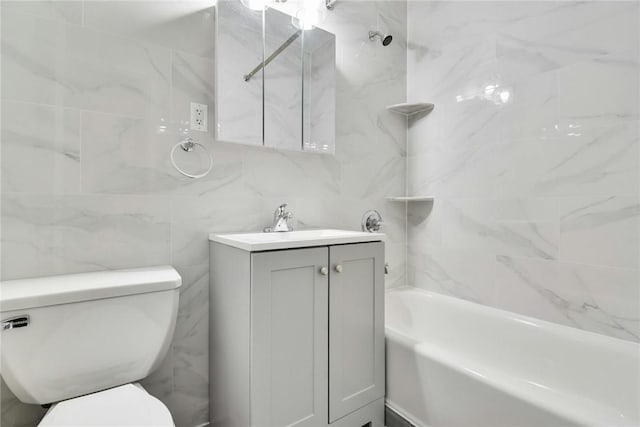 full bathroom featuring vanity, toilet, tile walls, and tiled shower / bath