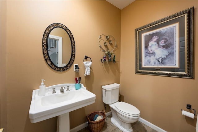 bathroom with tile patterned flooring and toilet