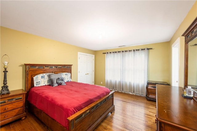 bedroom with hardwood / wood-style floors and a closet