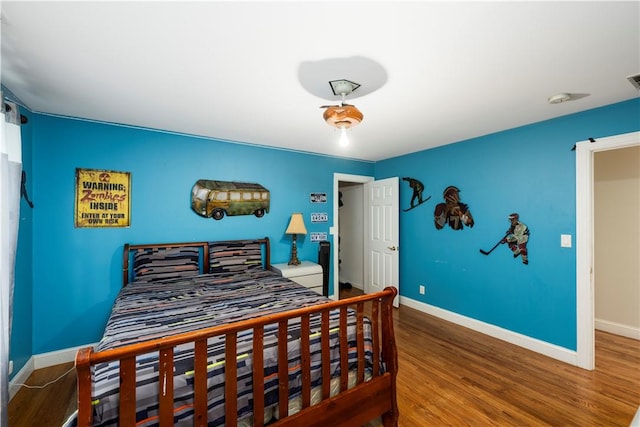 bedroom with hardwood / wood-style floors