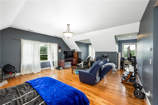 bedroom featuring hardwood / wood-style floors and lofted ceiling