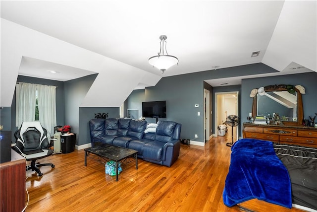 living room with wood-type flooring and lofted ceiling