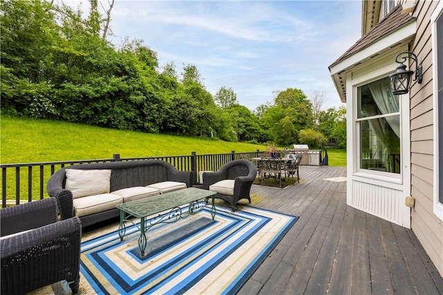 deck with an outdoor living space and a lawn