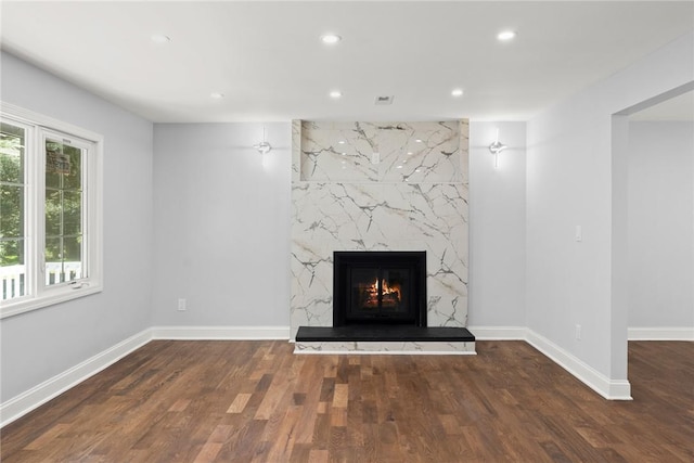 details with wood-type flooring and a high end fireplace