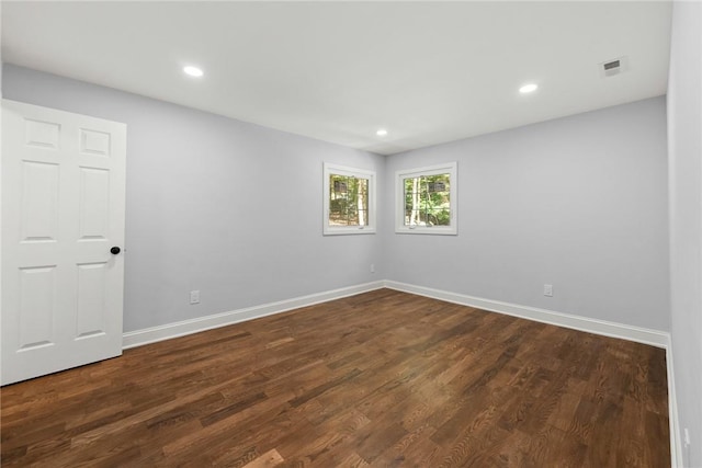 unfurnished room with dark hardwood / wood-style flooring