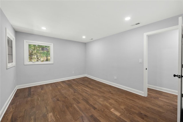 empty room featuring dark hardwood / wood-style flooring