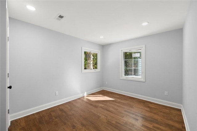 empty room with dark hardwood / wood-style floors