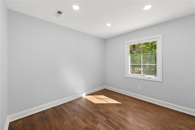 empty room featuring dark hardwood / wood-style flooring