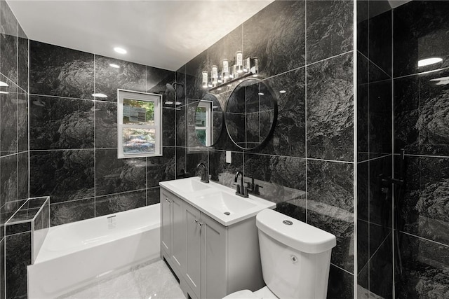 bathroom featuring vanity, tile walls, and toilet