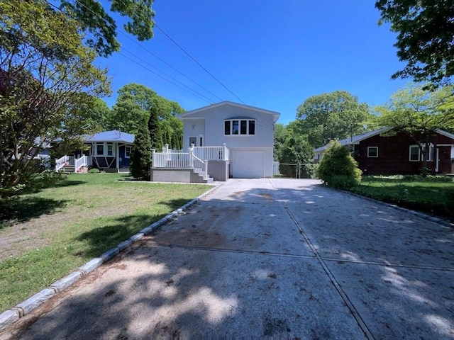 view of front facade with a garage and a front lawn