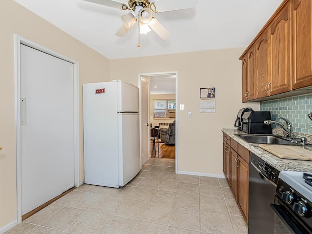 kitchen featuring ceiling fan, sink, decorative backsplash, light tile patterned flooring, and appliances with stainless steel finishes