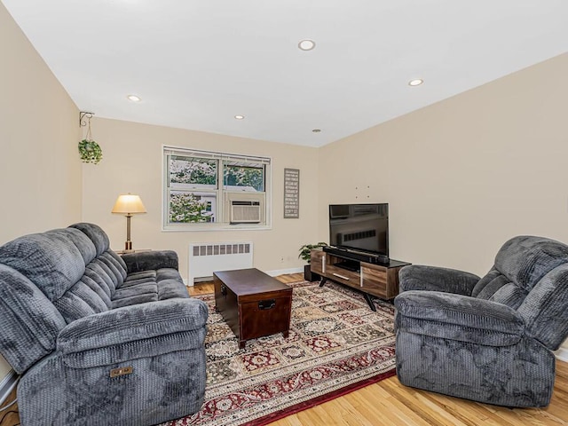 living room featuring hardwood / wood-style floors and radiator