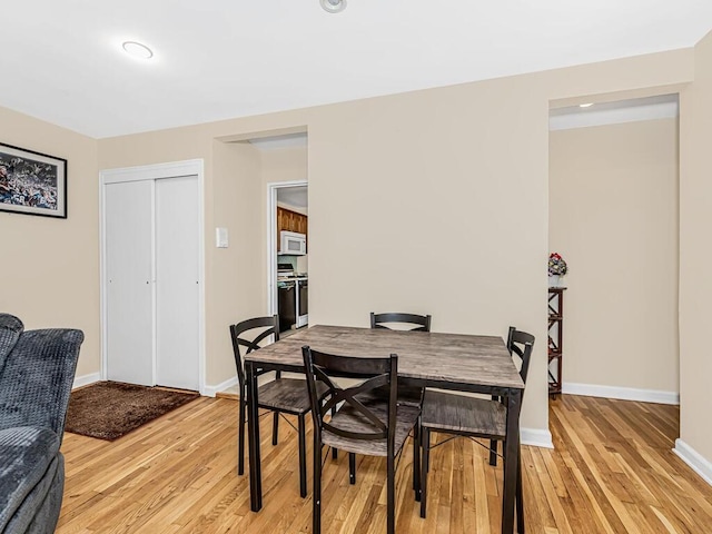 dining space with light hardwood / wood-style flooring