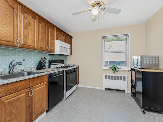 kitchen featuring ceiling fan, radiator heating unit, sink, tasteful backsplash, and white appliances