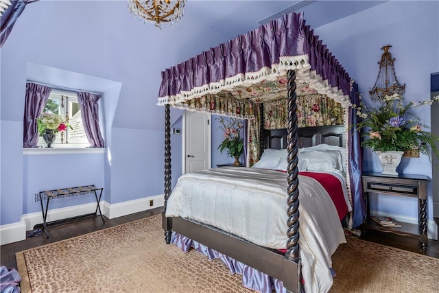 bedroom featuring dark hardwood / wood-style flooring and vaulted ceiling