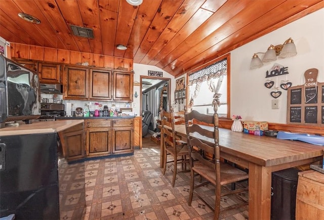 kitchen featuring wooden ceiling, black range, vaulted ceiling, decorative backsplash, and extractor fan