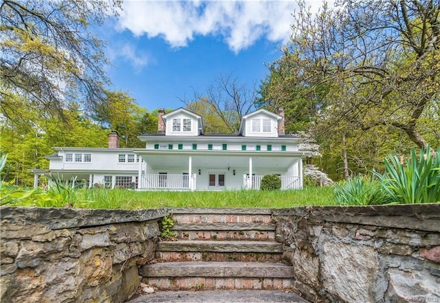 rear view of property with covered porch