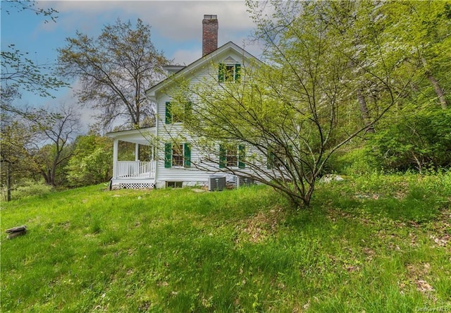 back of property featuring covered porch and central air condition unit