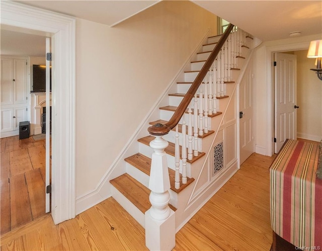 stairs with hardwood / wood-style flooring