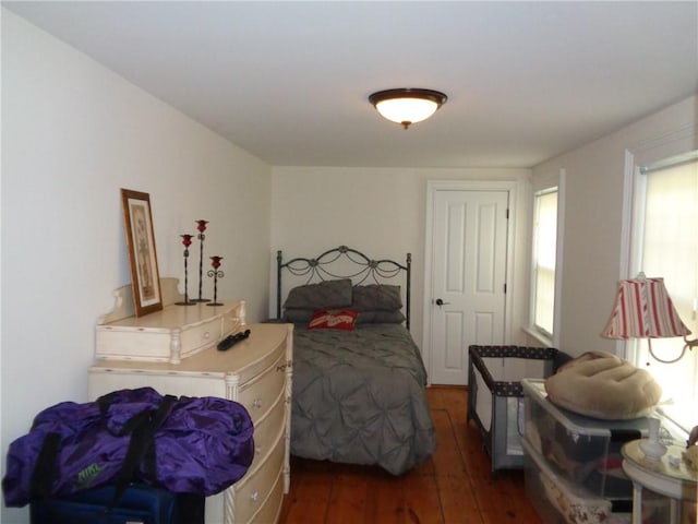 bedroom with dark wood-type flooring