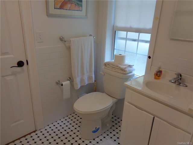 bathroom featuring tile patterned floors, vanity, and toilet