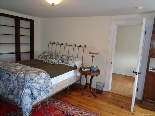 bedroom with hardwood / wood-style floors