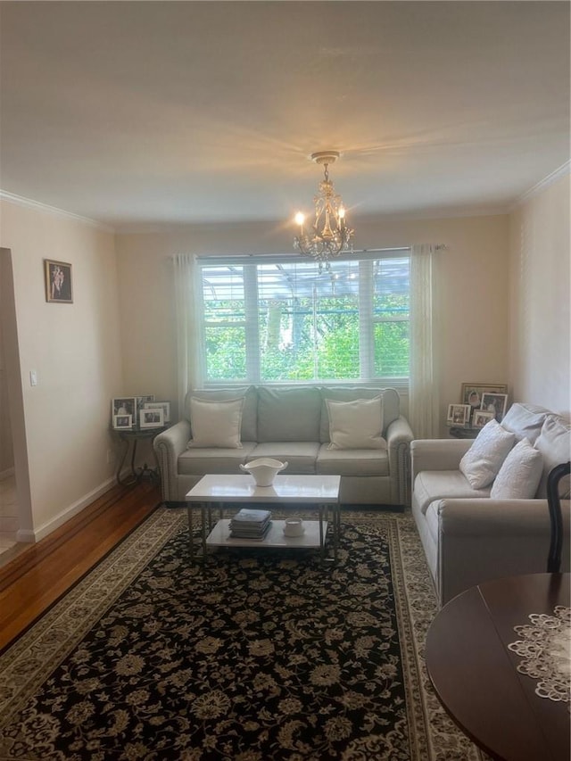 living room featuring a chandelier, hardwood / wood-style flooring, crown molding, and a healthy amount of sunlight