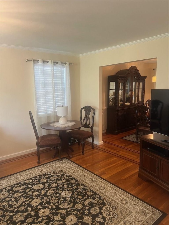 dining room featuring hardwood / wood-style floors and crown molding