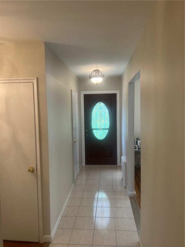 doorway featuring radiator heating unit and light tile patterned floors