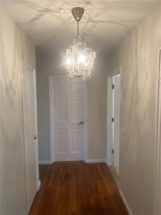 1357 Waring Ave, Bronx, NY 10469 - hallway featuring a chandelier, wood finished floors, and baseboards