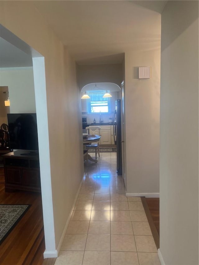 hallway with light hardwood / wood-style flooring