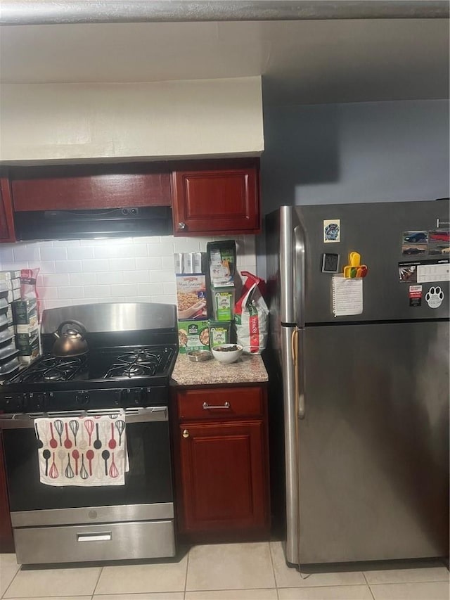 1357 Waring Ave, Bronx, NY 10469 - kitchen with appliances with stainless steel finishes, dark brown cabinets, light tile patterned floors, and backsplash