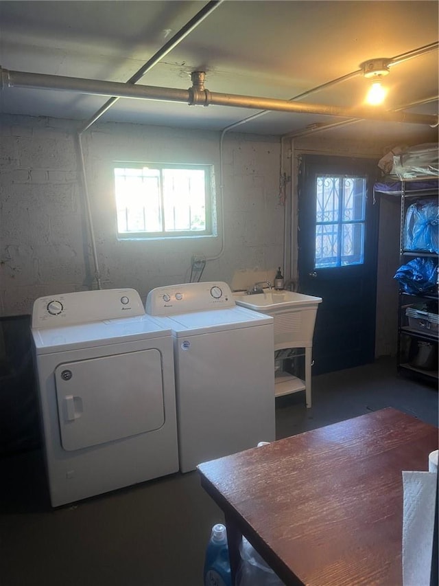 washroom with washing machine and dryer and a wealth of natural light