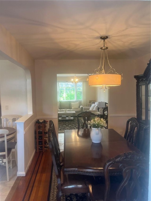 dining room featuring hardwood / wood-style flooring and an inviting chandelier