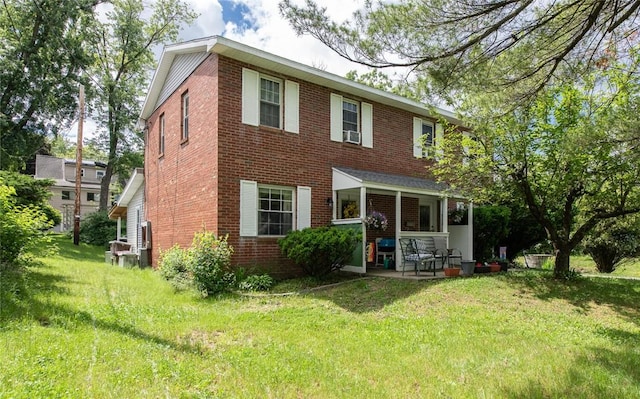 rear view of house featuring a yard and a patio