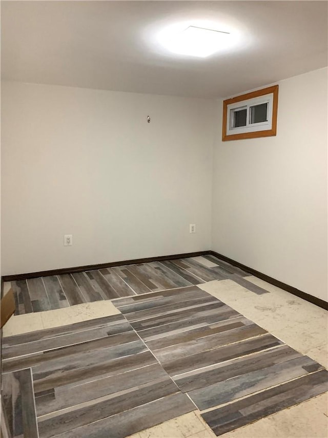 empty room with dark hardwood / wood-style flooring