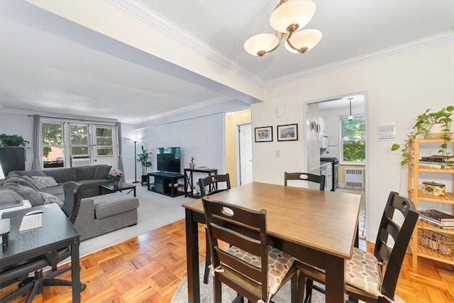 dining room with ornamental molding, light parquet flooring, and a notable chandelier