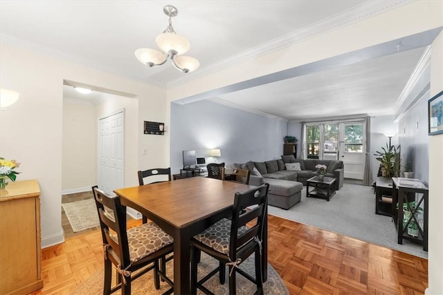 dining room featuring a notable chandelier, ornamental molding, and light parquet flooring