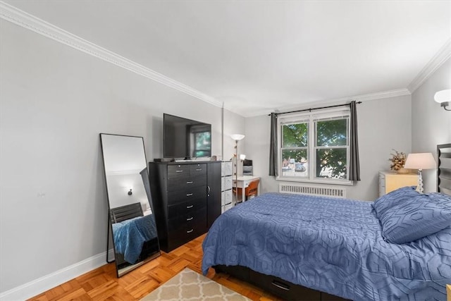 bedroom featuring ornamental molding, radiator heating unit, and light parquet floors