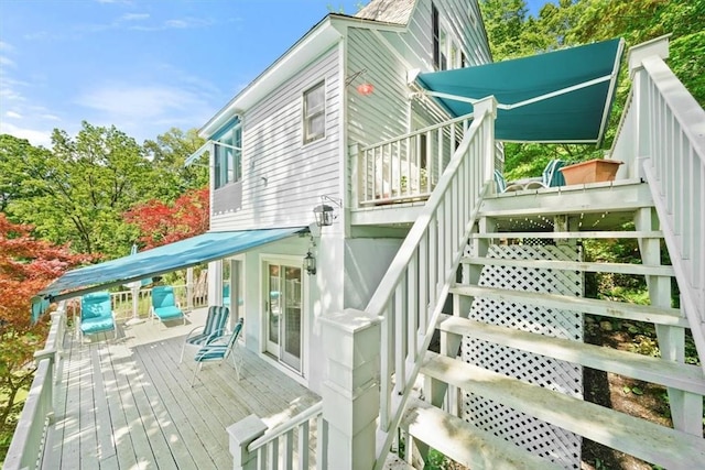 rear view of property featuring a deck