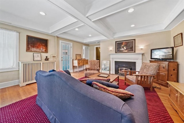 living room with a fireplace, beam ceiling, light hardwood / wood-style flooring, and coffered ceiling