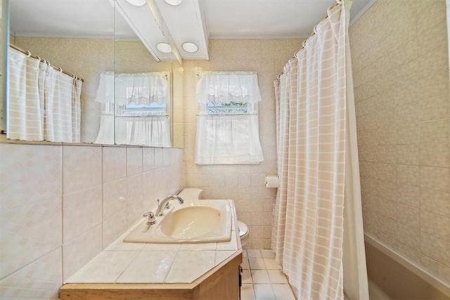 bathroom featuring tile patterned floors, vanity, and tile walls