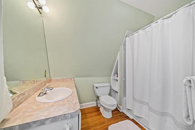 full bathroom with vanity, lofted ceiling, hardwood / wood-style flooring, toilet, and shower / bath combo with shower curtain