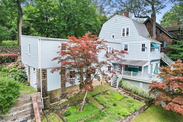 back of property with covered porch