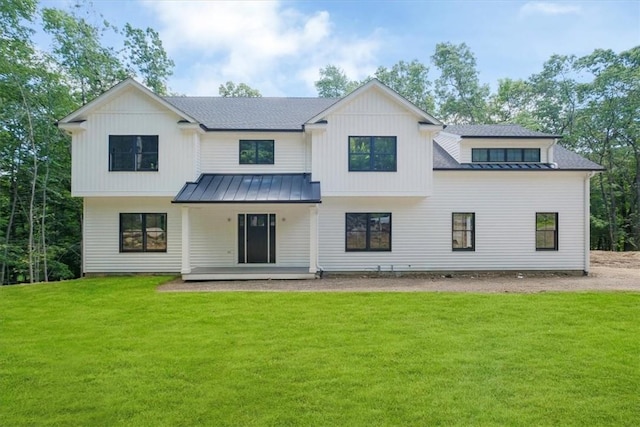 rear view of house with a lawn