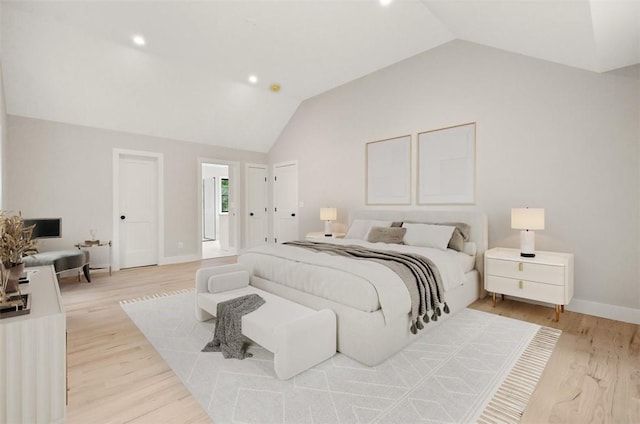 bedroom with lofted ceiling and light wood-type flooring