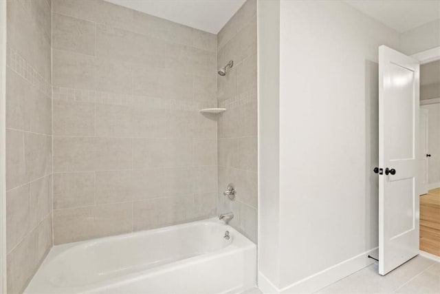 bathroom featuring tiled shower / bath combo and tile patterned flooring